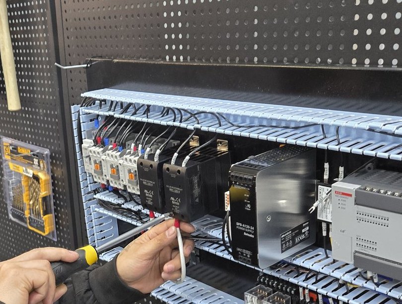 Control panel being wired by hand